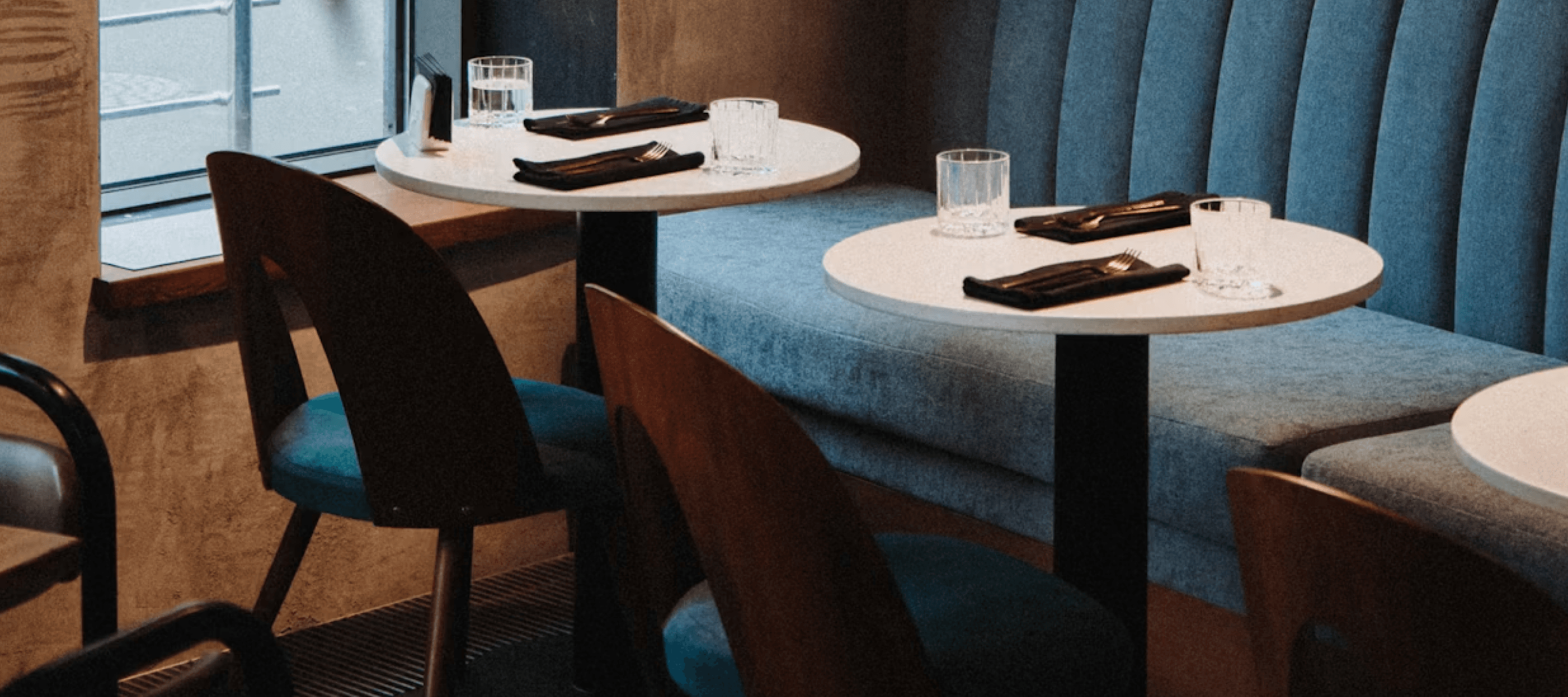 Tables set in a restaurant - illustrating the hospitality and food service sector